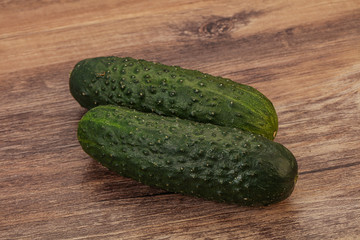 Green fresh cucumbers over background