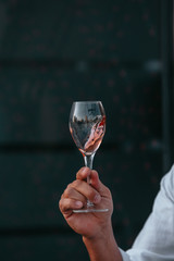 Glass of white sparkling wine at a summer tasting in the hand of a model.