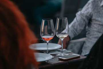 Glass of white sparkling wine at a summer tasting in the hand of a model.