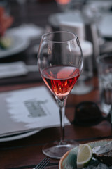 Glass of white sparkling wine at a summer tasting in the hand of a model.