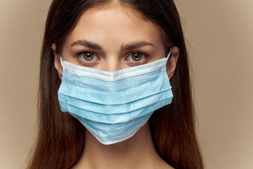 Girl protective medical mask looks forward brunette naked neck