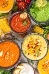 Different autumn soups set. Assortment vegetable soups in portion bowls - corn, potato, pumpkin, tomato, zucchini, broccoli cream soups. top view copy space