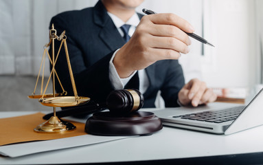 Business and lawyers discussing contract papers with brass scale on desk in office. Law, legal services, advice, justice and law concept picture with film grain effect