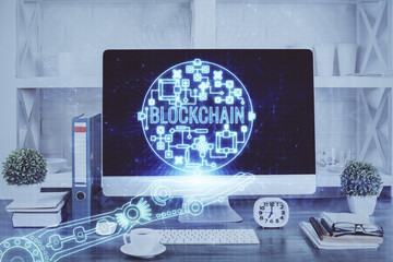 Fototapeta premium Double exposure of blockchain and crypto economy theme hologram and table with computer background. Concept of bitcoin cryptocurrency.