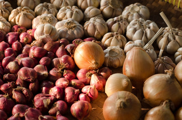 Garlic, Onion And Spices on wooden background. Selective focus.