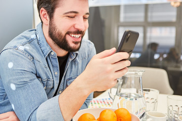 Man is happy while chatting with the smartphone