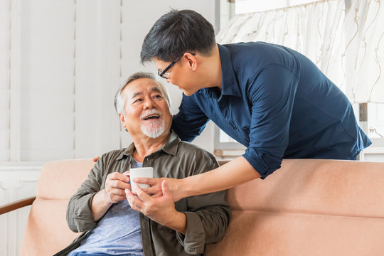 Cheerful senior asian father and middle aged son in living room, Happiness Asian family concepts