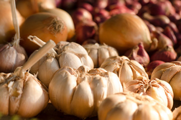 Garlic, Onion And Spices on wooden background. Selective focus.