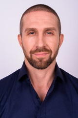 Obraz premium Face of handsome bald bearded businessman looking at camera