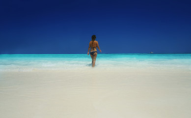 young woman walking on the beach