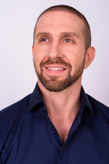 Fototapeta premium Portrait of happy handsome bald bearded businessman