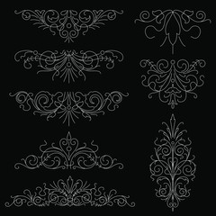 Vector set of calligraphic design elements isolated on black background