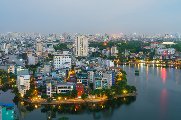 Fototapeta na wymiar Hanoi cityscape with skyline view during sunset period at West Lake ( Ho Tay ) in 2020