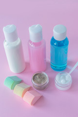 SPA treatment for skin, cleansing, nourishing and respecting. Scrub, lotion, skin cream on pink wooden background