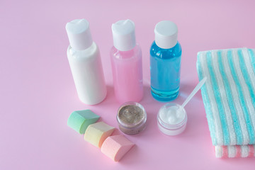 Body and face care concept. Cleansing food and respect, spa treatments. Bottles with cream, lotion and scrub on pink background. SPA concept, relaxation