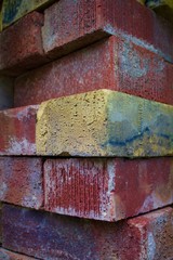 A pile of standard modular bricks from an industrial yard.