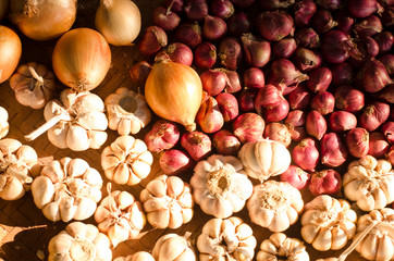 Garlic, Onion And Spices on wooden background. Selective focus.