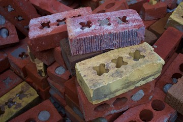 A pile of standard modular bricks from an industrial yard.