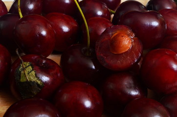 Closeup ripe red cherry, cut into half with stone