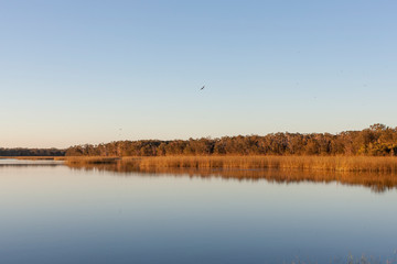 Obraz na płótnie Canvas Sunrise over the calm lake
