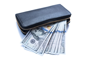 Hundred dollar bills stacked in handbag on background