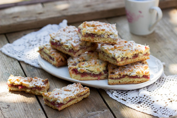Streusel pie stuffed with rose jam, served with coffee. Rustic style.