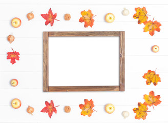 Naklejka na ściany i meble Rough frame made of wood and bright autumn leaves on a white wooden background