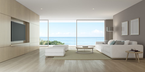 3D rendering of modern living room with TV screen and sofa on sea background.	