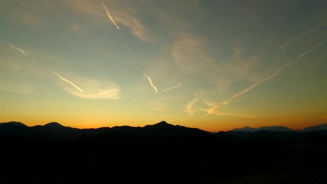 Sunset sky with plane trails.