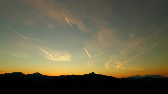 Sunset sky with plane trails.