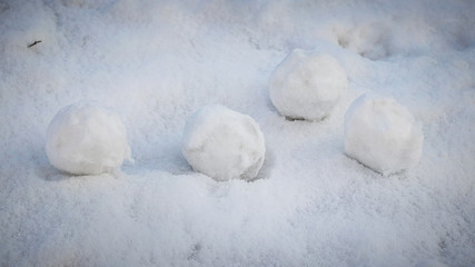Fototapeta na wymiar Snowballs lie on the snow. Playing snowballs