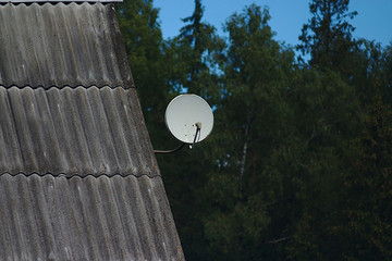 satellite dish on the roof of a village house