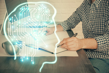 Man typing on keyboard background with brain hologram. Concept of big Data. Double exposure.