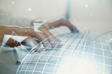 Double exposure of world map hologram with man working on computer on background. Concept of...