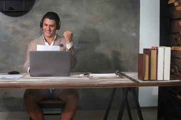 Young businessman uses online video conference to work from home during coronavirus covid 19 outbreak as a new normal lifestyle for self quarantine