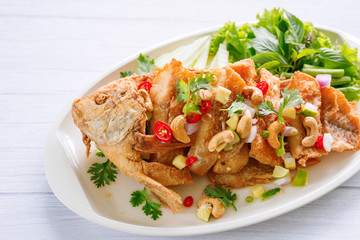 Fried Fish with herb and spicy sauce thai food.