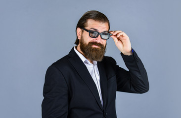 official office lifestyle. cheerful bearded man. handsome and successful man in expensive suit. He is in white shirt and glasses. stylish successful man in suit posing. business man wear suit