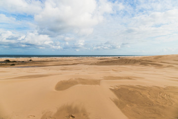 Fototapeta na wymiar Sand dunes view with beach at the distance.