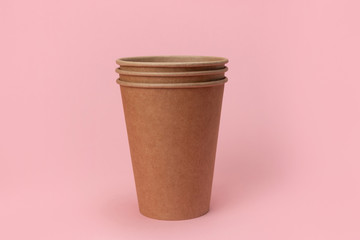 cardboard disposable cup for coffee isolated on pink background