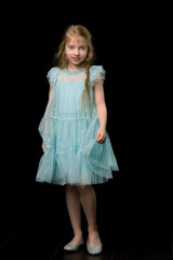 Cute little girl in a light summer dress.