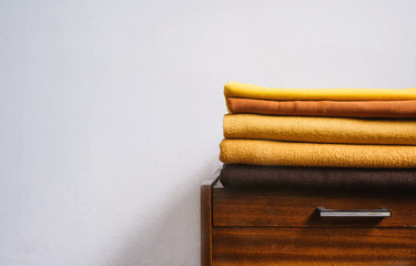 Fall autumn Minimalism, simple, Neutral color negative space background mockup with copy space. Fall autumn color palettes compositions with stack of yellow brown fabrics