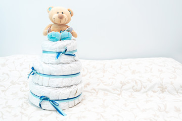 baby diaper cake present with toy teddy bear for the expectant family. set with blue colors for...