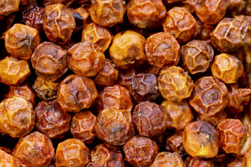 super macro shot of dried red kampot pepper from Cambodia  in detail very close. food background.