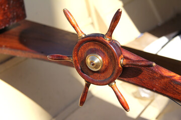 Close-up of the steering wheel of the ship as a decoration. The ship's wheel is on the deck.