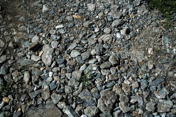 The stone lies on the ground on a summer day.