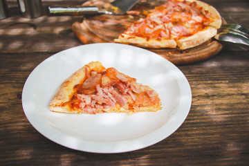 meat lovers pizza with topping pepperoni salami sausage and ham on wooden table