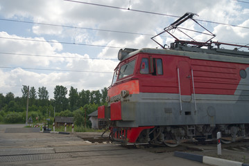 the driver's cabin of the train is at the crossing