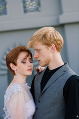 Nice redhead young just married happy couple kissing in the sunset outdoors