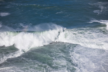 Foamy stong waves crashing in the ocean