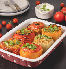 Colored stuffed peppers with potato, carrot, garlic, onion and parsley. Healthy Mediterranean food and dieting concept, close up view. Served and ready to eat.